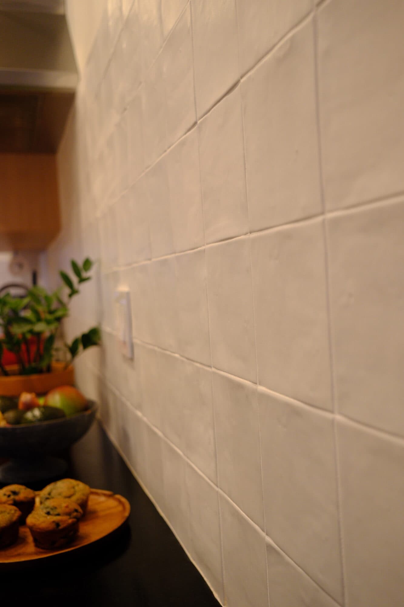 Handmade-look white floor tile detail in the finished kitchen