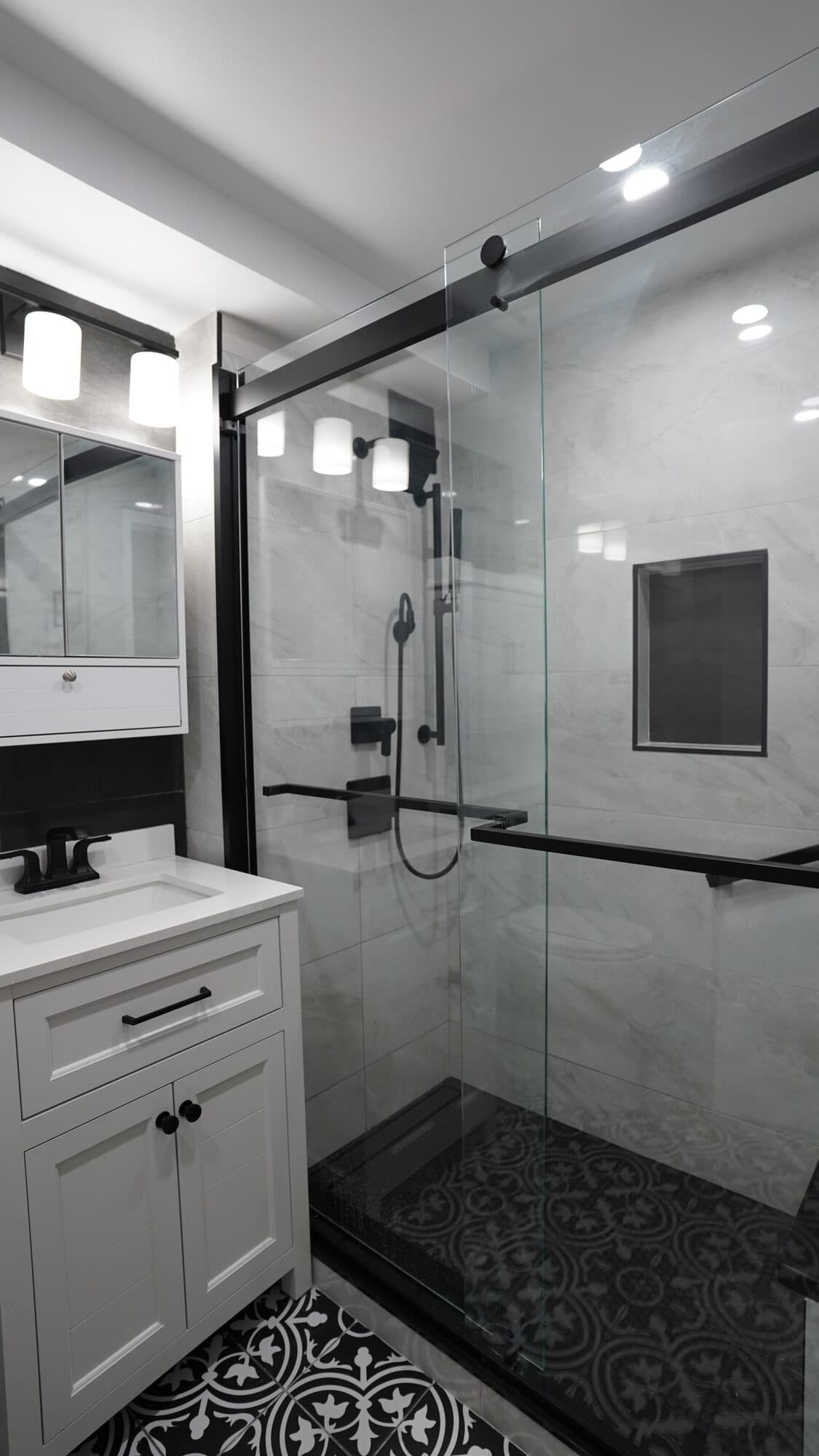 View across the renovated bathroom from the shower with patterned tile floor