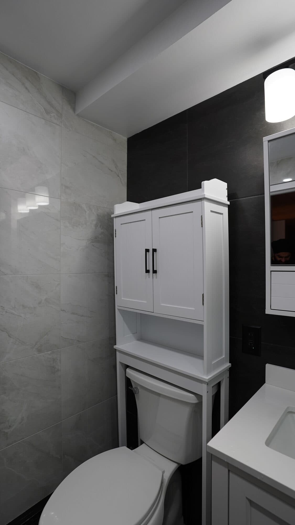 Over-toilet storage cabinet in the renovated Clinton Hill bathroom