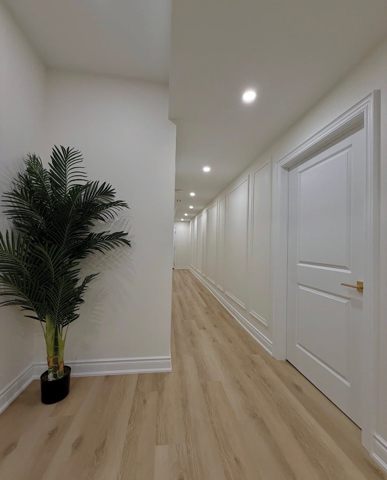 Panel-molded hallway with light oak flooring in the FiDi apartment