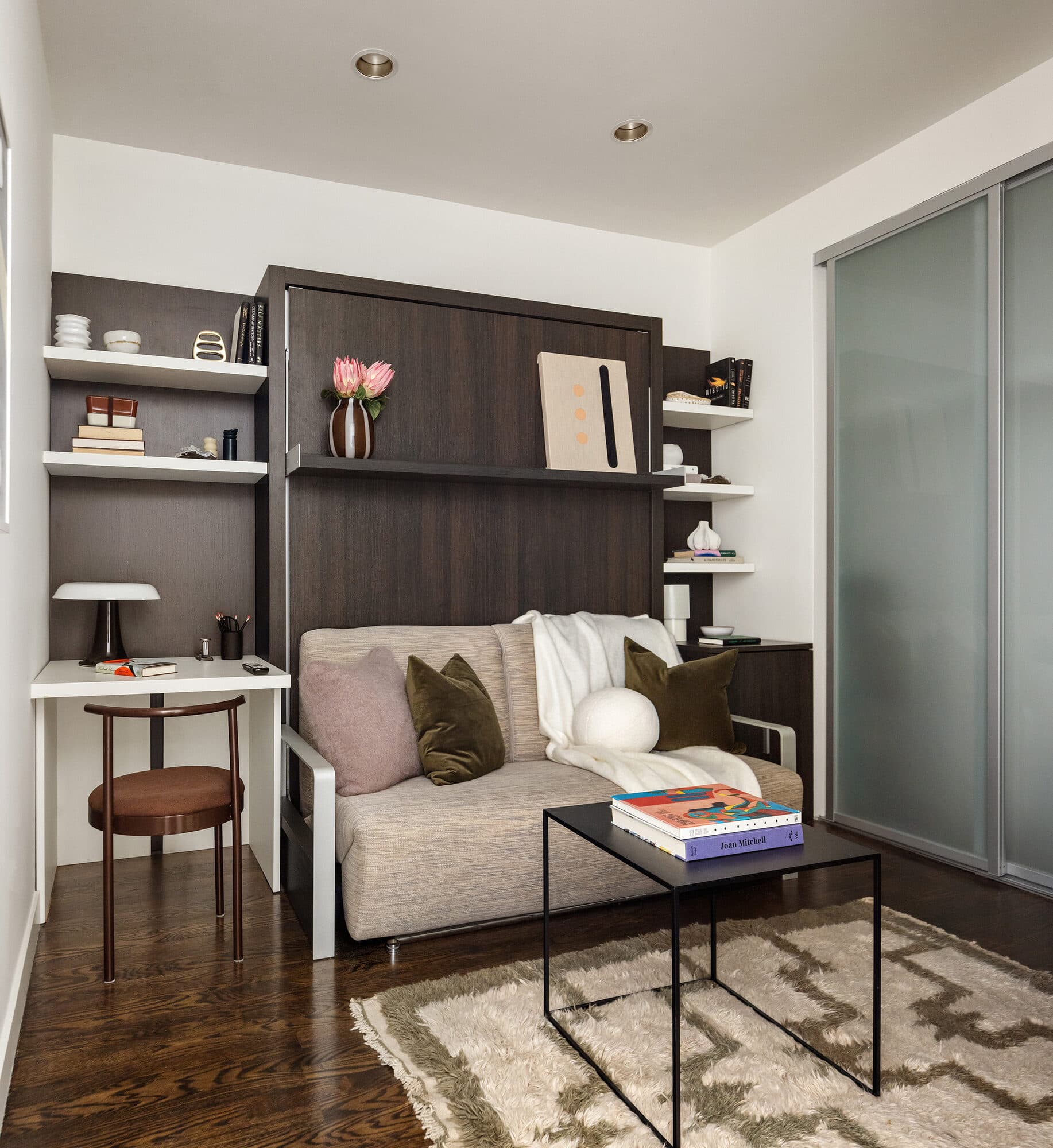 Guest room with built-in murphy bed and shelving after the renovation
