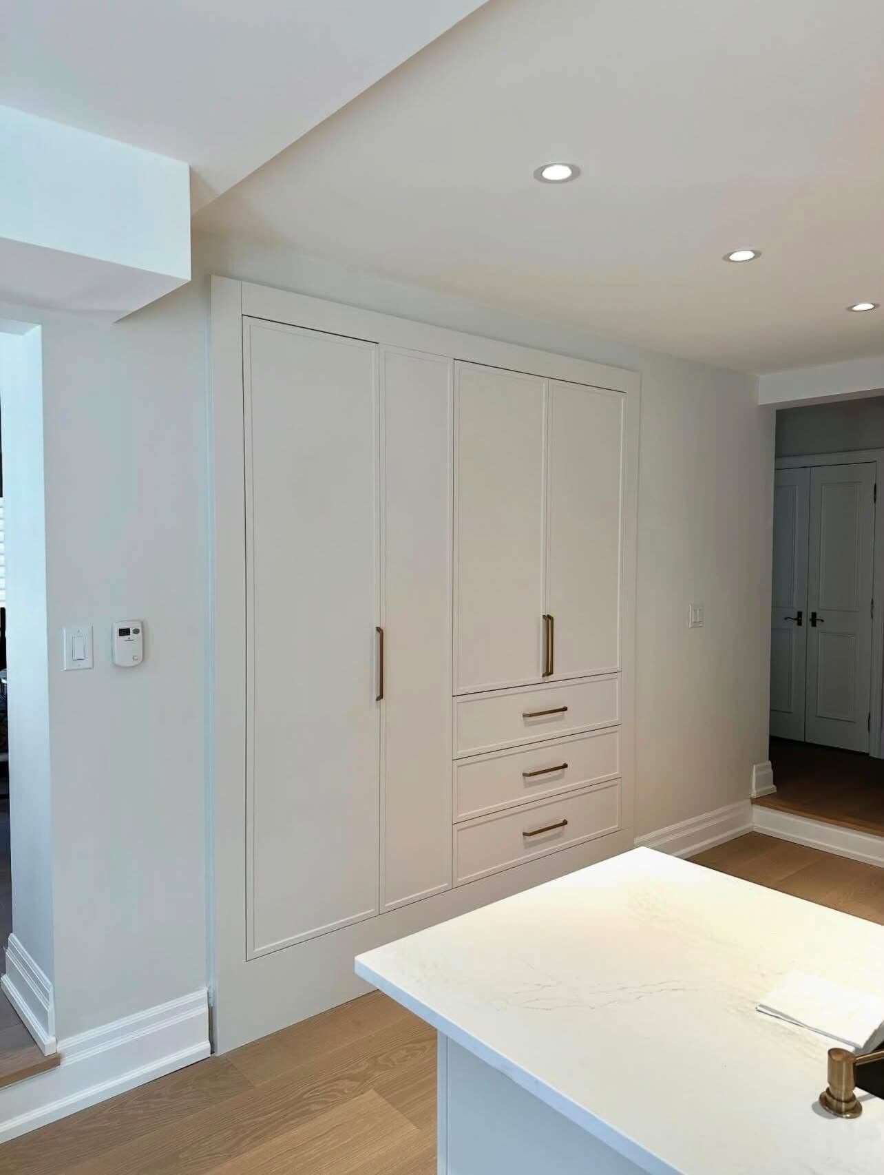 Angled view of the pantry wall beside the island in the renovated kitchen