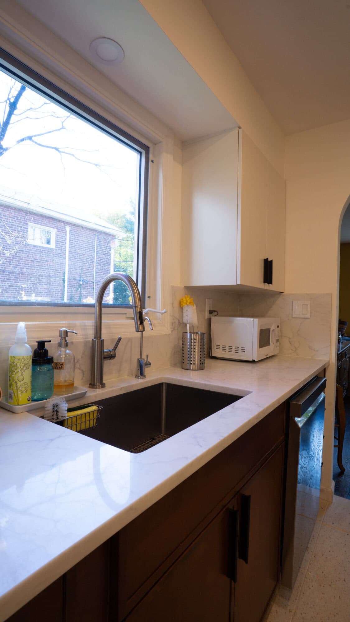 Kitchen sink under a picture window in the Riverdale renovation